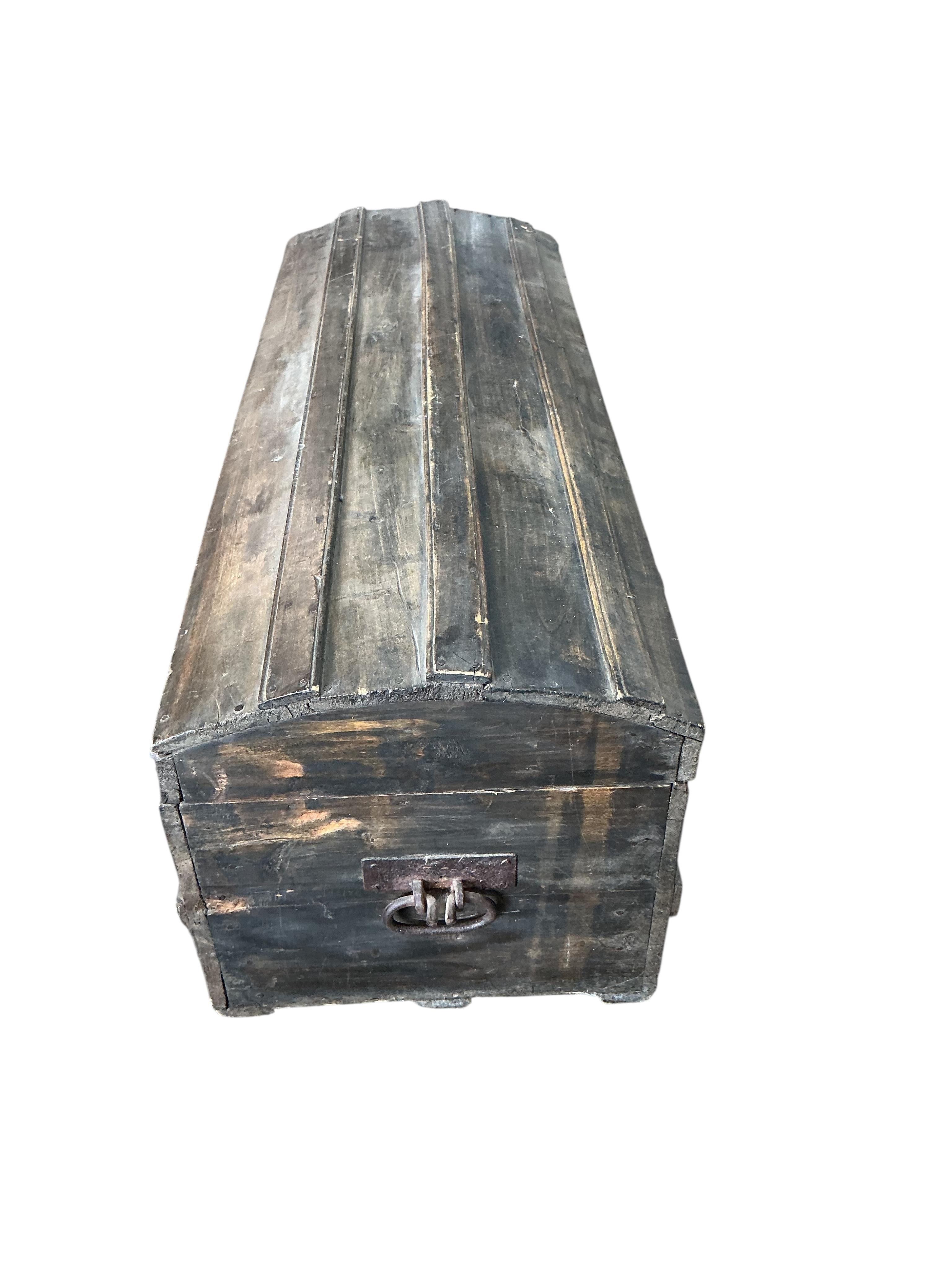 A stained pine domed top trunk, width 123cm, depth 46cm, height 47cm